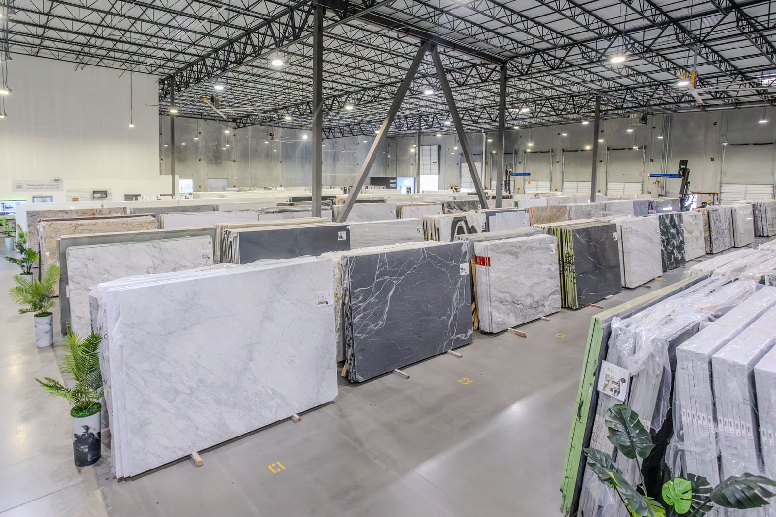 The CRS gallery floor in Austin: rows of full marble and quartzite slabs, racked and gallery-lit